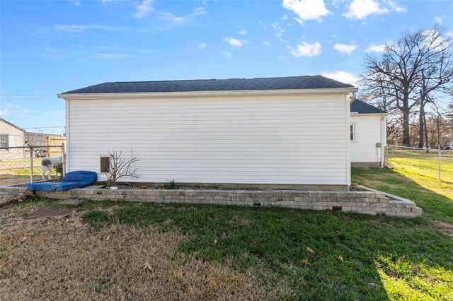 view of side of property with a yard