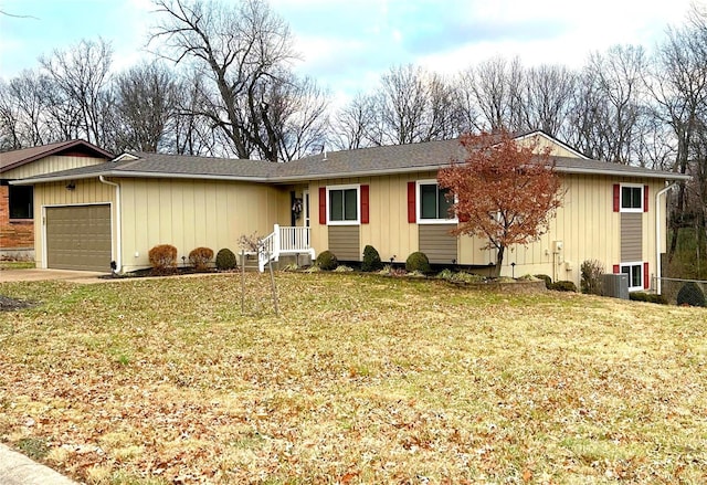 ranch-style house featuring a front yard and a garage