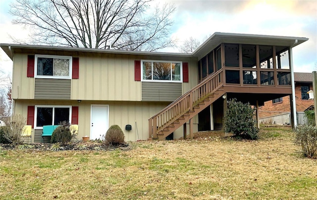 back of property featuring a sunroom and a yard