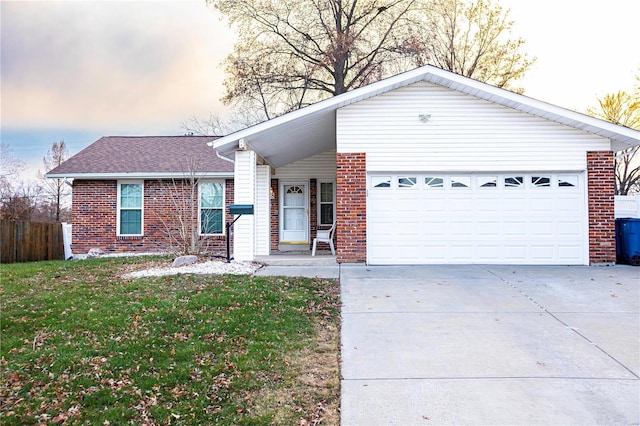 ranch-style house with a garage and a yard