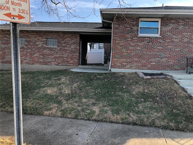 property entrance with a lawn