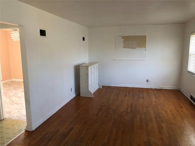 empty room featuring dark hardwood / wood-style flooring