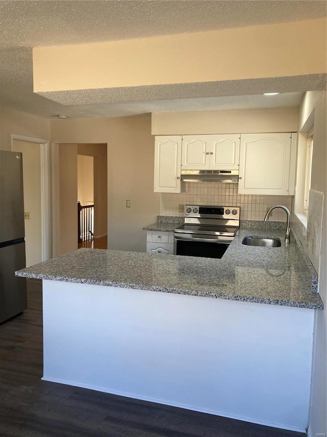 kitchen featuring light stone countertops, white cabinetry, sink, stainless steel appliances, and dark hardwood / wood-style floors