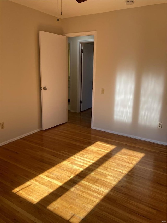 unfurnished room featuring ceiling fan and dark hardwood / wood-style floors