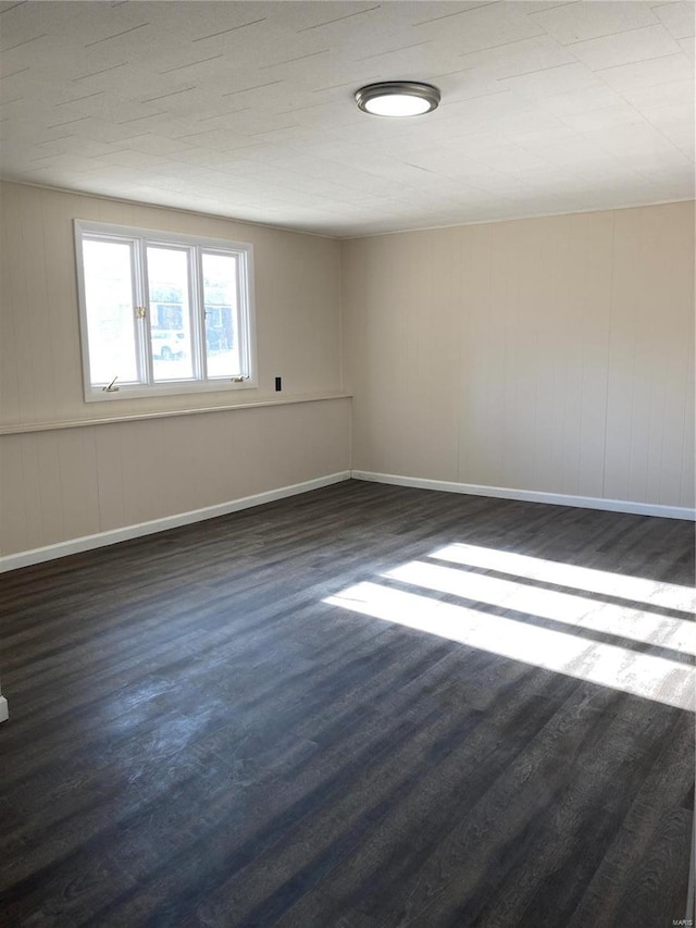 spare room with dark hardwood / wood-style floors