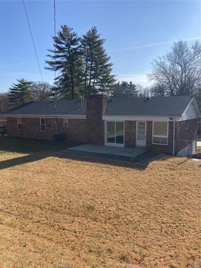 back of property featuring a lawn and a patio