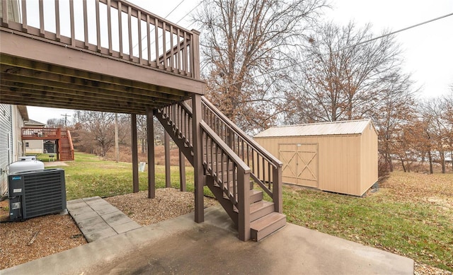 view of patio / terrace with central AC, a storage unit, and a wooden deck