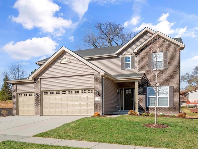 view of property featuring a garage and a front lawn