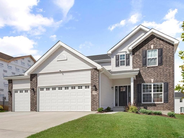 view of front of property with a garage and a front yard