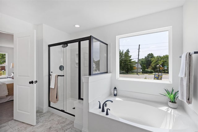 bathroom with shower with separate bathtub