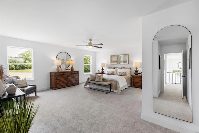 carpeted bedroom featuring ceiling fan and multiple windows