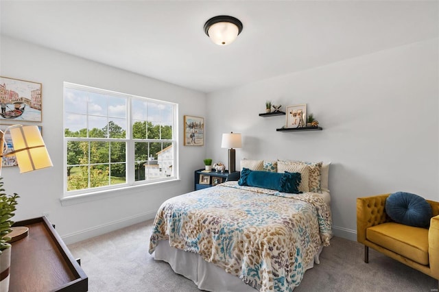 bedroom featuring light carpet