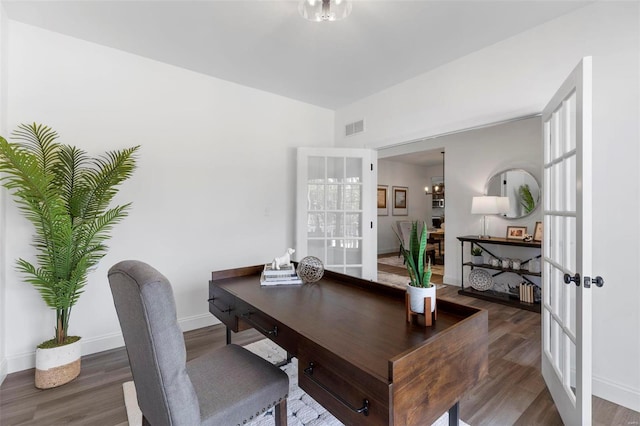 office space with french doors, dark hardwood / wood-style floors, and a notable chandelier