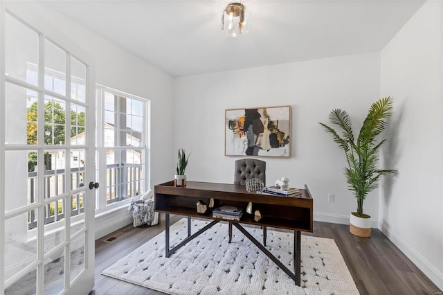 office area with plenty of natural light and dark wood-type flooring