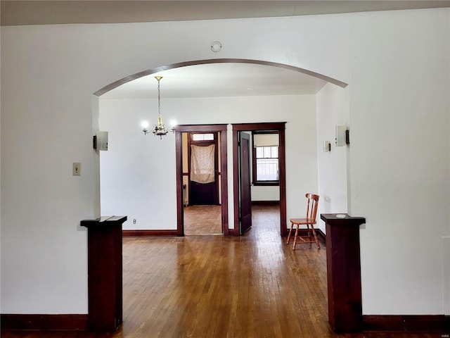 interior space featuring dark hardwood / wood-style flooring and an inviting chandelier