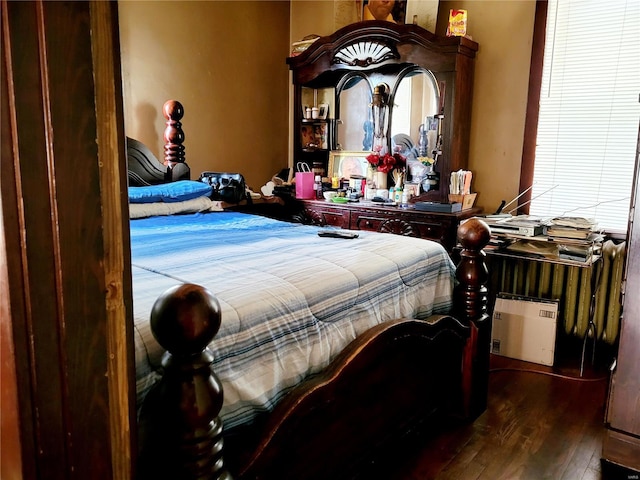 bedroom with dark hardwood / wood-style floors