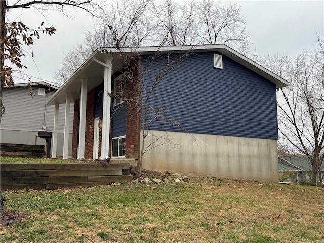 view of home's exterior with a yard