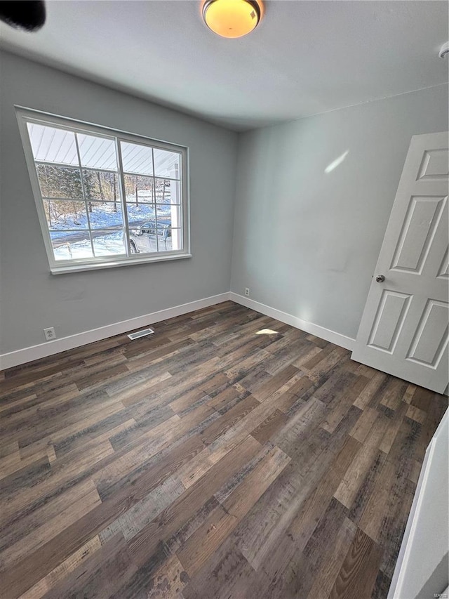 unfurnished room featuring dark hardwood / wood-style floors