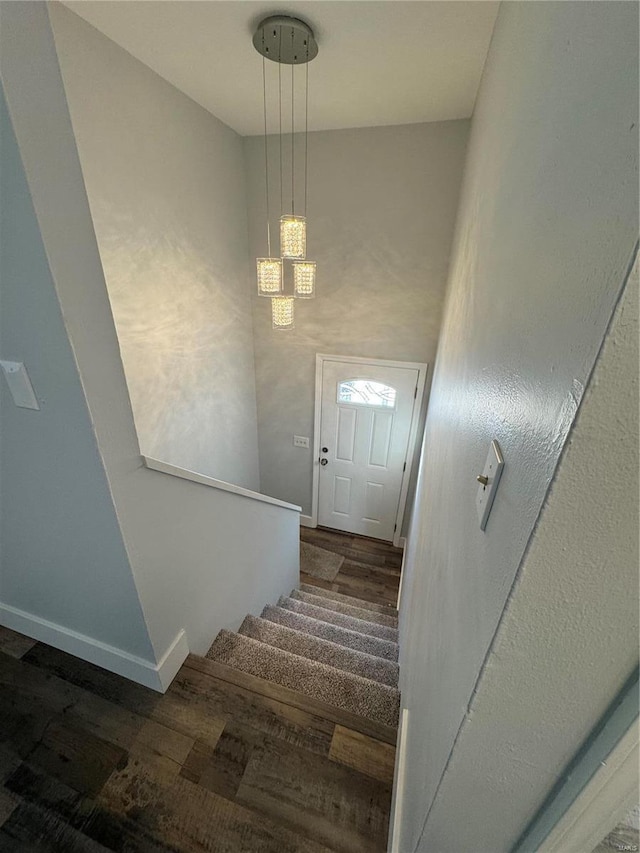 staircase with hardwood / wood-style floors