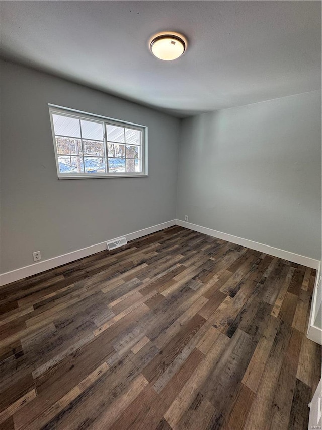 unfurnished room with dark hardwood / wood-style floors