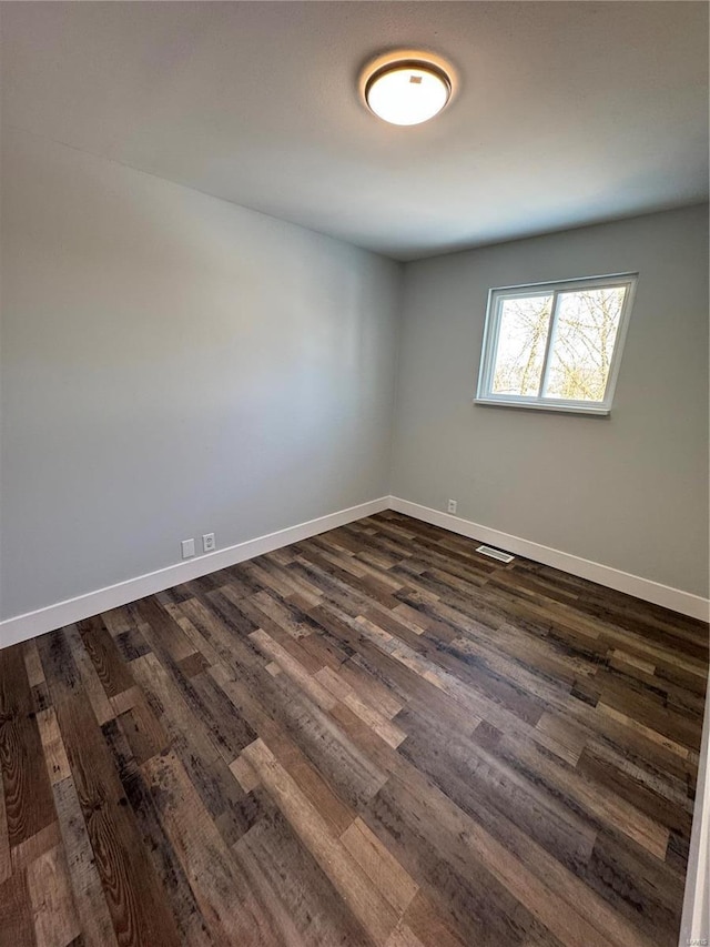 spare room with dark hardwood / wood-style floors