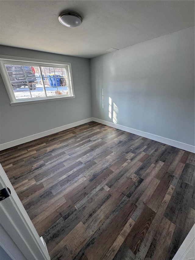 spare room featuring dark hardwood / wood-style flooring