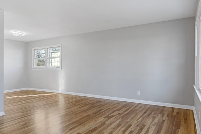 empty room with hardwood / wood-style flooring