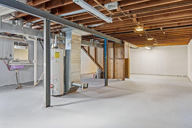 basement featuring gas water heater and sink