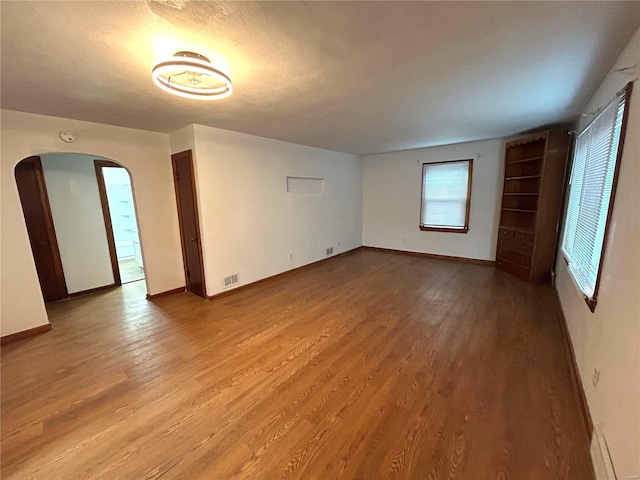 unfurnished room with light wood-type flooring