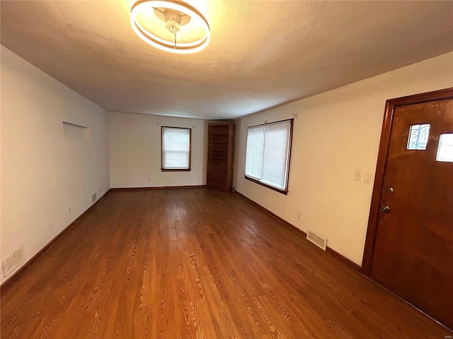 unfurnished room with hardwood / wood-style flooring