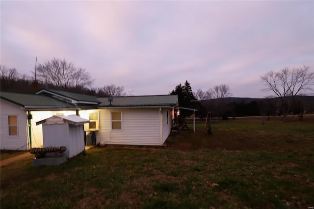 property exterior at dusk with a yard