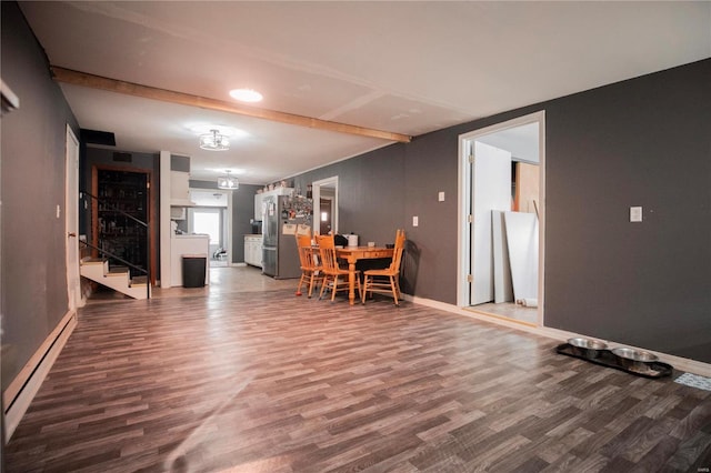 unfurnished dining area with a baseboard radiator, wood-type flooring, and beam ceiling