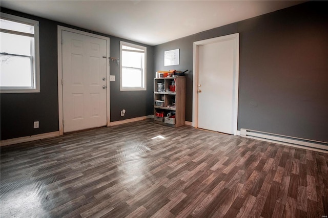 foyer entrance featuring dark wood-type flooring and baseboard heating