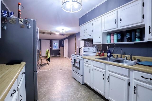 kitchen featuring white cabinetry, sink, stainless steel refrigerator, and white range with electric stovetop