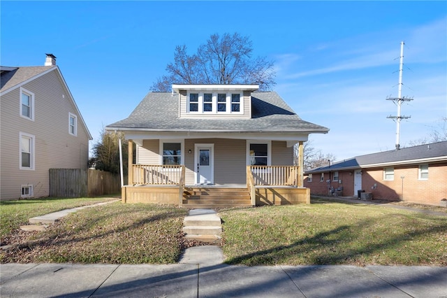 bungalow-style home featuring covered porch and a front lawn