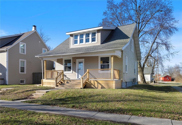 bungalow-style home featuring covered porch and a front yard