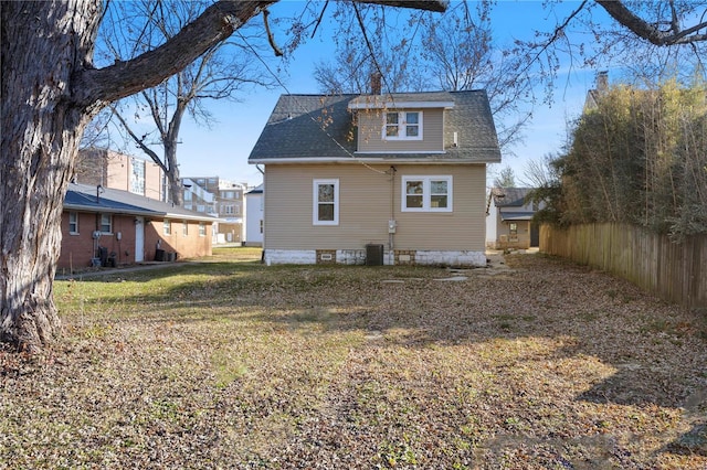 back of house featuring a lawn and central AC unit