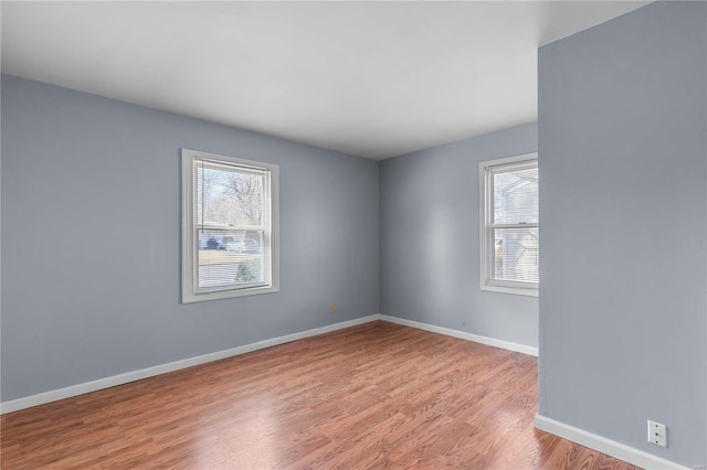 empty room featuring light hardwood / wood-style flooring and a healthy amount of sunlight