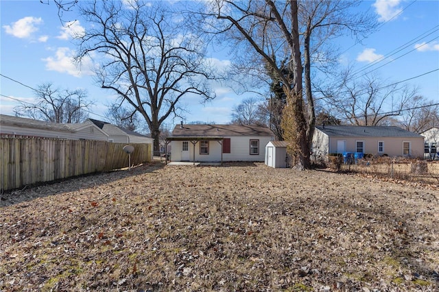 back of house featuring a storage shed