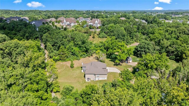 aerial view featuring a forest view and a residential view