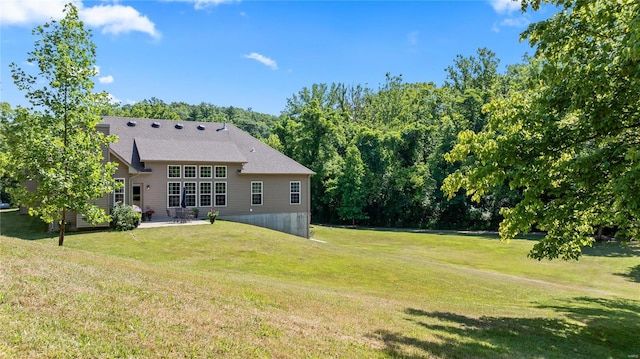 back of property featuring a lawn and a patio