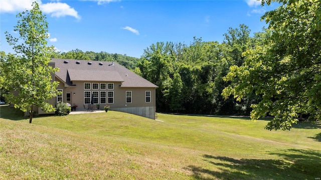 back of property featuring a patio area and a lawn