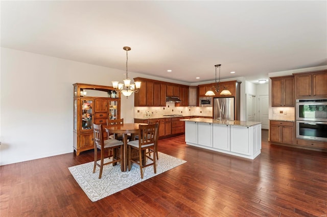 dining room featuring a chandelier, dark wood-style flooring, and recessed lighting