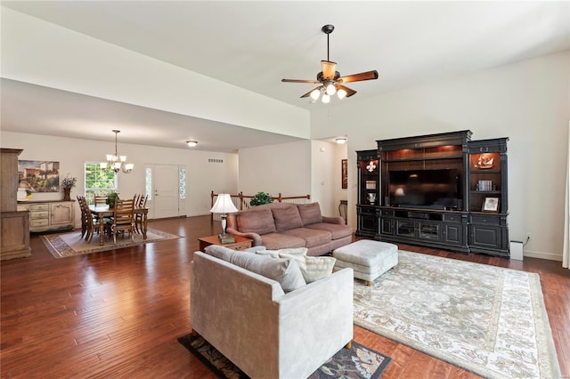 living area featuring wood finished floors and ceiling fan with notable chandelier