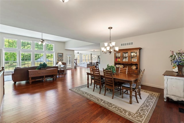 dining area featuring ceiling fan with notable chandelier, a wealth of natural light, visible vents, and wood finished floors