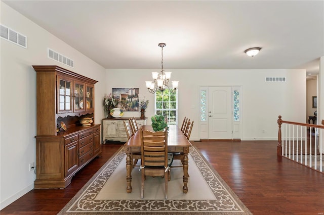 dining room with dark wood-style flooring, visible vents, and baseboards