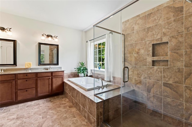 full bathroom with a sink, double vanity, a stall shower, and a garden tub