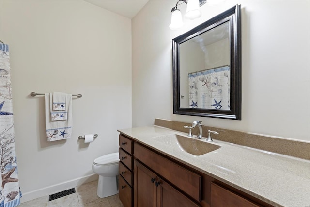 bathroom with visible vents, toilet, vanity, baseboards, and tile patterned floors