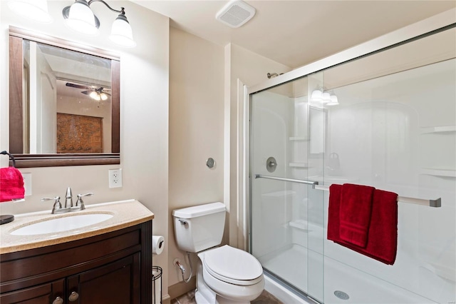 full bath with visible vents, toilet, a shower stall, and vanity