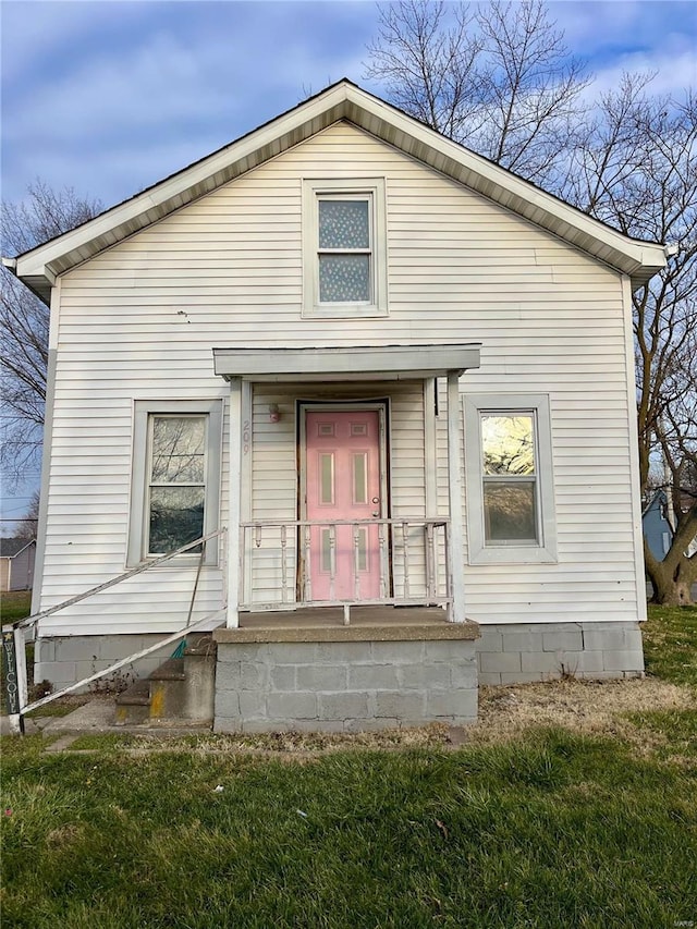 back of house with a lawn